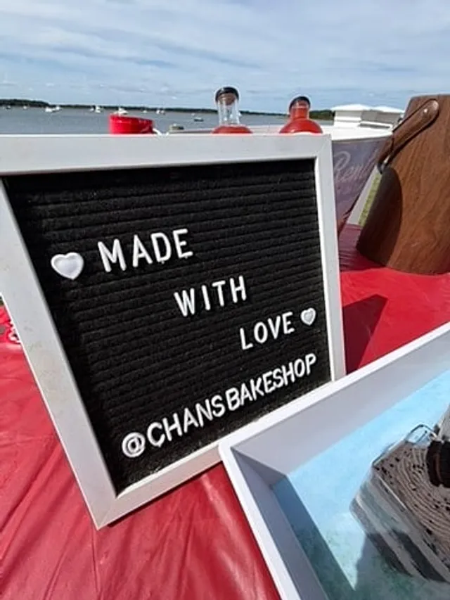 A letterboard that reads made with love, @chansbakeshop